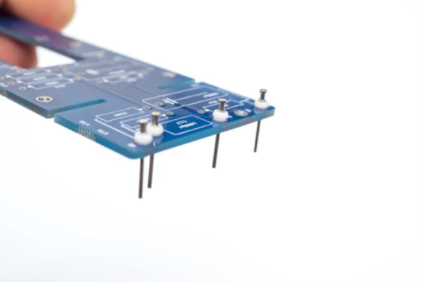D-12 PCB with five turret pins being installed at the BD, BG, BP, Grid, and FD positions.